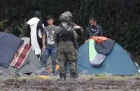 Мигранты на белорусской границе / Reuters